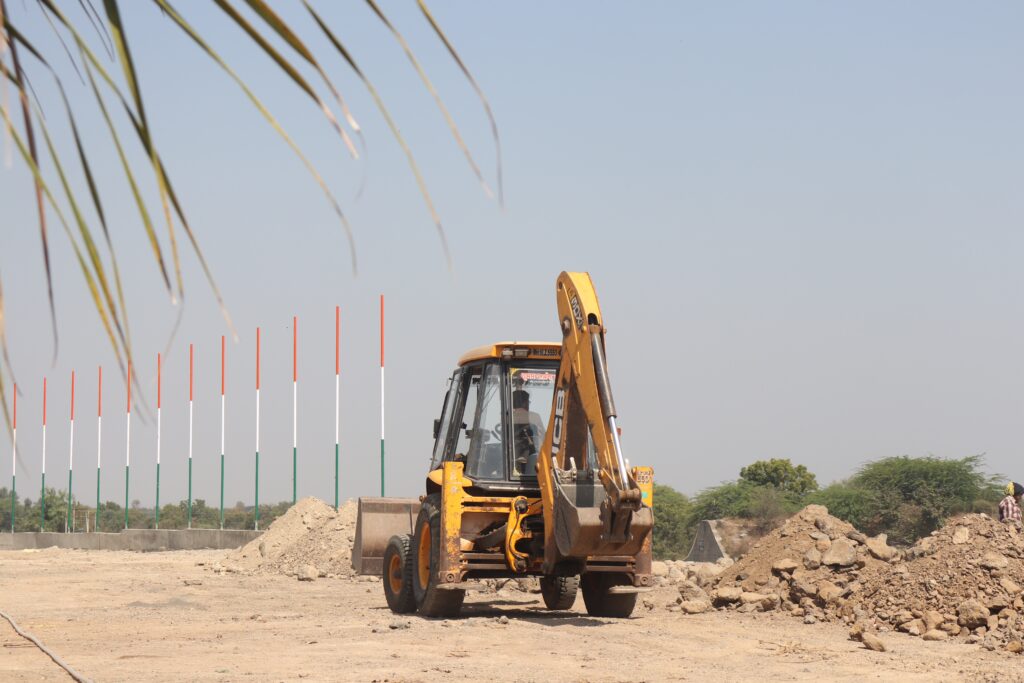 Heavy machines digging soil in a field