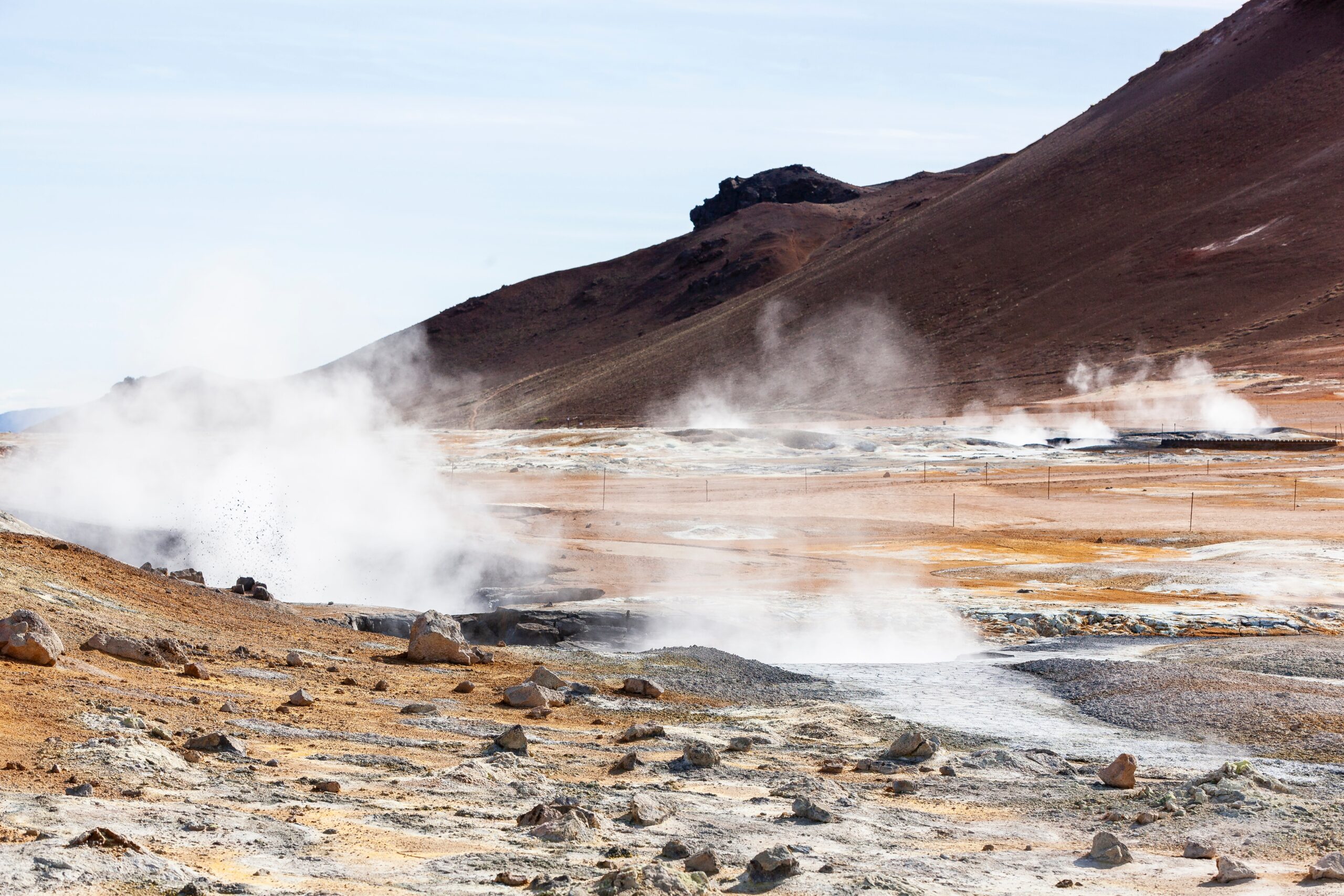 Geothermal exploration illustration depicting scientists from Shinka Geoscience company drilling into the Earth's crust to harness geothermal energy.